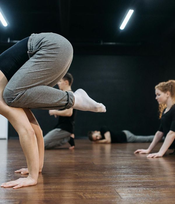 Woman holding a challenging yoga pose, demonstrating core strength and balance.